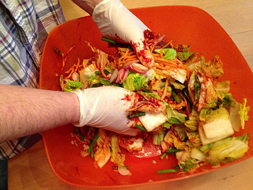 kimchi ingredients being massaged prior to fermentation